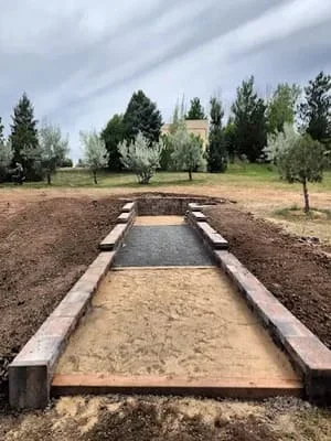 Newly constructed bocce ball court with timber borders and sand playing surface in Littleton
