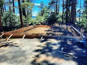 Cleared forest lot with removed trees and graded soil in Littleton